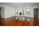 This large living room has wood floors, large windows, and white walls at 1225 Pitts Chapel, Newborn, GA 30056