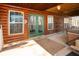 Covered outdoor patio area of log cabin style home, including table, hot tub and outdoor furniture at 1225 Pitts Chapel, Newborn, GA 30056