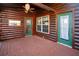 A covered porch with a ceiling fan, log siding, and views of the surrounding landscape at 1225 Pitts Chapel, Newborn, GA 30056