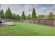 A spacious lawn surrounded by a tall wooden fence offers plenty of room at 1570 Shire Village Dr, Sugar Hill, GA 30518