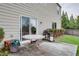 Patio features a circular table, sliding doors, and outdoor grill at 1570 Shire Village Dr, Sugar Hill, GA 30518