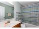 Full bathroom with modern vanity and shower-over-tub with striped curtain at 1570 Shire Village Dr, Sugar Hill, GA 30518