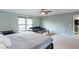Bright bedroom with a ceiling fan, large bed, sitting area and natural light streaming in from two large windows at 1570 Shire Village Dr, Sugar Hill, GA 30518