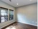 Bright bedroom featuring wood-look floors, neutral walls, and natural light streaming through the windows at 1570 Shire Village Dr, Sugar Hill, GA 30518