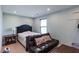 A simple bedroom features soft lighting and a versatile sofa at 1570 Shire Village Dr, Sugar Hill, GA 30518