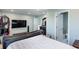 Open bedroom shows a large screen TV and ensuite bathroom entrance at 1570 Shire Village Dr, Sugar Hill, GA 30518