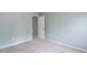 A view of an empty bedroom showcasing neutral-colored walls and carpet, an open doorway, and bright natural lighting at 1570 Shire Village Dr, Sugar Hill, GA 30518