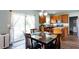 Well-lit dining area next to the kitchen features a glass table, and sliding door to the outdoors at 1570 Shire Village Dr, Sugar Hill, GA 30518