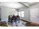 Comfortable dining area featuring a table with seating for six, wood floors, and bright natural lighting at 1570 Shire Village Dr, Sugar Hill, GA 30518