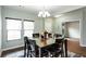 The dining room is bright with natural light from windows and has wood flooring at 1570 Shire Village Dr, Sugar Hill, GA 30518