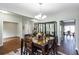 Bright dining room features modern chandelier, wood floors, and room for six at 1570 Shire Village Dr, Sugar Hill, GA 30518