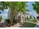 Well-maintained townhome featuring lush landscaping, a welcoming entrance, and ample natural light at 1570 Shire Village Dr, Sugar Hill, GA 30518