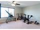 Bright home gym featuring various workout equipment and a ceiling fan for a comfortable exercise environment at 1570 Shire Village Dr, Sugar Hill, GA 30518