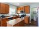 Kitchen features wood cabinets, stainless steel appliances, and an island at 1570 Shire Village Dr, Sugar Hill, GA 30518