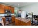 Kitchen features stainless steel appliances, wood cabinets, and a center island at 1570 Shire Village Dr, Sugar Hill, GA 30518