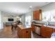 Open concept living space with dining room and kitchen featuring wood floors at 1570 Shire Village Dr, Sugar Hill, GA 30518
