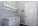 Mudroom with storage shelves and coat hooks next to the door to the outside at 1570 Shire Village Dr, Sugar Hill, GA 30518