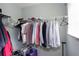 Neat walk-in closet is equipped with shelves and rods for organized storage at 1570 Shire Village Dr, Sugar Hill, GA 30518