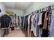 Well-organized walk-in closet with hanging racks and plenty of storage space for clothes and accessories at 1570 Shire Village Dr, Sugar Hill, GA 30518
