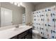 Bright bathroom featuring a modern vanity and shower with decorative curtain at 2170 Trelipe Dr, Lawrenceville, GA 30044