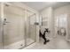 Tiled shower with glass door and exercise bike in bathroom at 2170 Trelipe Dr, Lawrenceville, GA 30044