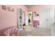 Well-organized pink bedroom with ample storage and cozy seating at 2170 Trelipe Dr, Lawrenceville, GA 30044