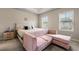Serene bedroom with tray ceilings, pink furnishings, and natural light at 2170 Trelipe Dr, Lawrenceville, GA 30044