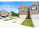 Brick townhome with a two-car garage and a concrete driveway surrounded by green grass at 2170 Trelipe Dr, Lawrenceville, GA 30044
