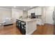 Open-concept kitchen featuring a large island with seating and hardwood floors at 2170 Trelipe Dr, Lawrenceville, GA 30044