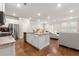 Modern kitchen with granite countertops, stainless steel appliances, and open living space at 2170 Trelipe Dr, Lawrenceville, GA 30044