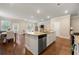 Kitchen island with granite countertops opens up to the dining and living areas at 2170 Trelipe Dr, Lawrenceville, GA 30044