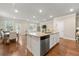 Open concept kitchen and living area with lots of natural light and hardwood flooring at 2170 Trelipe Dr, Lawrenceville, GA 30044
