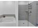 Bathroom featuring a soaking tub, and glass enclosed shower with tiled walls at 1393 Halpern Nw Ln, Kennesaw, GA 30144