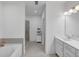 Modern bathroom with a soaking tub, glass-enclosed shower, and dual sink vanity with white cabinets at 1393 Halpern Nw Ln, Kennesaw, GA 30144