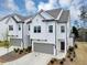 Charming two-story home with white siding, gray roof, attached garage, and manicured landscaping at 1393 Halpern Nw Ln, Kennesaw, GA 30144