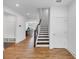 Bright entryway with hardwood floors, staircase, and convenient built-in storage at 1393 Halpern Nw Ln, Kennesaw, GA 30144