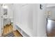 Hallway with storage bench, view of the powder room, and access to the open-concept living areas at 1393 Halpern Nw Ln, Kennesaw, GA 30144