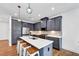 Modern kitchen with gray cabinets, stainless steel appliances, an island with a white countertop, and pendant lighting at 1393 Halpern Nw Ln, Kennesaw, GA 30144