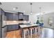 Modern kitchen with stainless steel appliances, kitchen island, and stylish pendant lighting at 1393 Halpern Nw Ln, Kennesaw, GA 30144