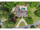 An aerial view showcases the backyard pool, putting green, circular driveway, and lush landscaping at 194 Sentinel Se Pl, Marietta, GA 30067