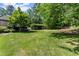 Lush green backyard with well-manicured lawn and a putting green at 194 Sentinel Se Pl, Marietta, GA 30067