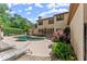 Stucco home exterior with a lush backyard featuring an in-ground pool with lounge chairs at 194 Sentinel Se Pl, Marietta, GA 30067