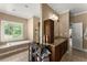 The bathroom features a sunken tub, large window, granite countertop, and built in storage at 194 Sentinel Se Pl, Marietta, GA 30067