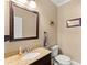 Charming powder room with granite countertop, framed mirror, and neutral tones at 194 Sentinel Se Pl, Marietta, GA 30067