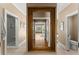 Hallway leading to the bathroom showcases a beautiful mirror and entrances to the toilet and shower stall at 194 Sentinel Se Pl, Marietta, GA 30067