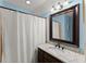 Well-lit bathroom featuring granite counters, vanity, framed mirror, and shower at 194 Sentinel Se Pl, Marietta, GA 30067
