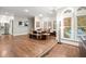 Bright dining area with hardwood floors, a natural wood table, with a view of the backyard pool at 194 Sentinel Se Pl, Marietta, GA 30067