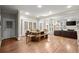 Open concept dining area with natural light, adjacent to the living room, hardwood floors and modern table at 194 Sentinel Se Pl, Marietta, GA 30067
