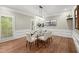 Chic dining room featuring a modern light fixture, seating for six, hardwood floors and views of the outdoors at 194 Sentinel Se Pl, Marietta, GA 30067