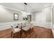 Elegant dining room with modern light fixture, seating for six, hardwood floors, crown molding and neutral walls at 194 Sentinel Se Pl, Marietta, GA 30067